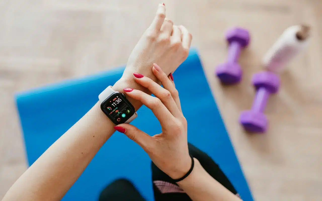 Person checking a smartwatch before an early morning or evening workout