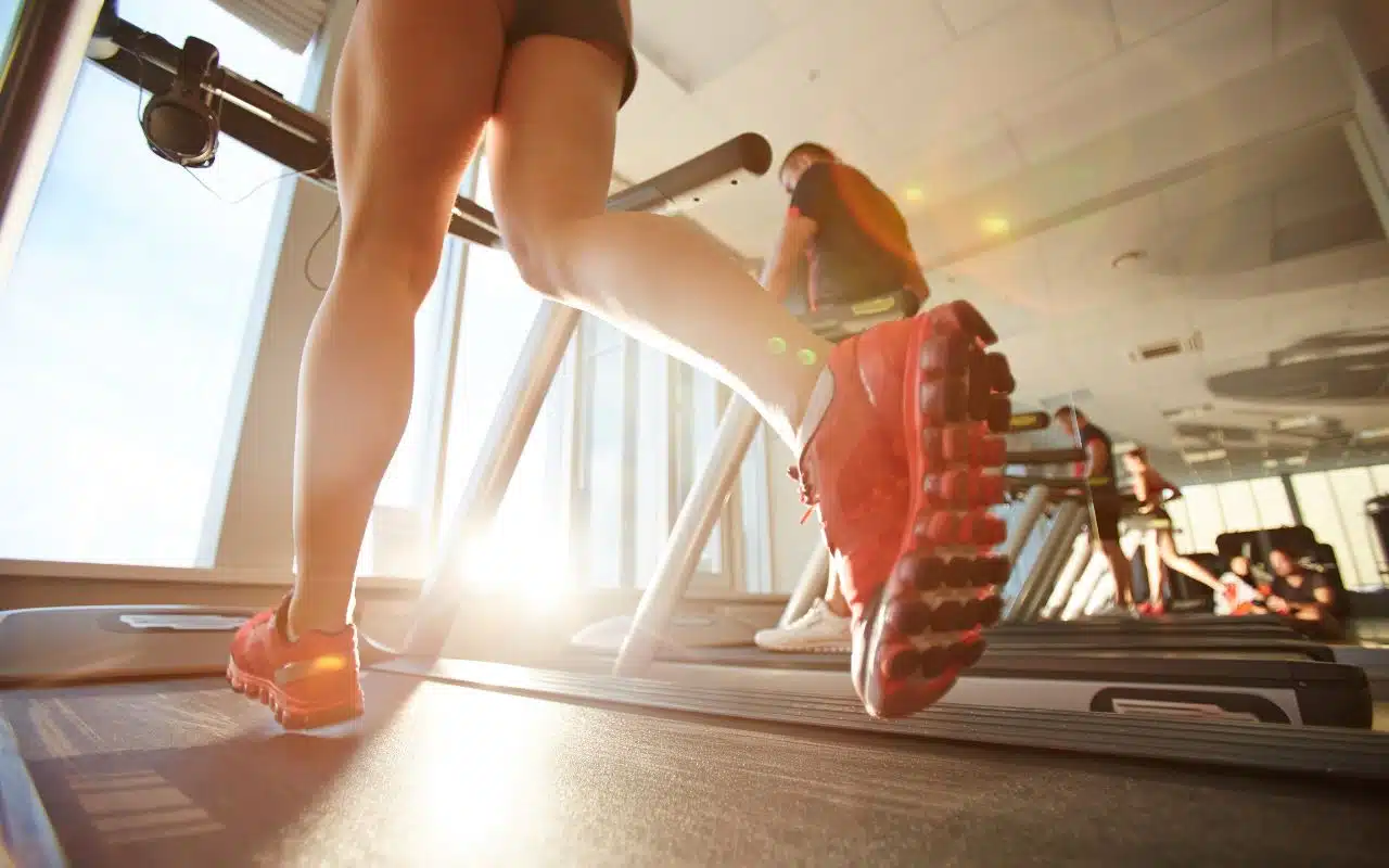 Person running on a treadmill to support physical and mental health